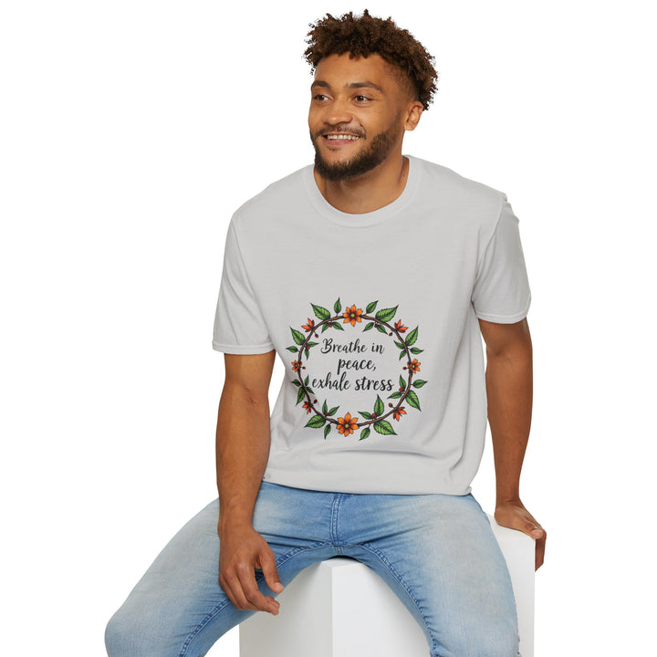 A close-up image of a white t-shirt with a beautiful floral garland design and the words Breathe in Peace Exhale Stress printed in cursive font