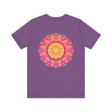 A vibrant and colorful pink and yellow mandala T-shirt featuring a design that represents peace and harmony