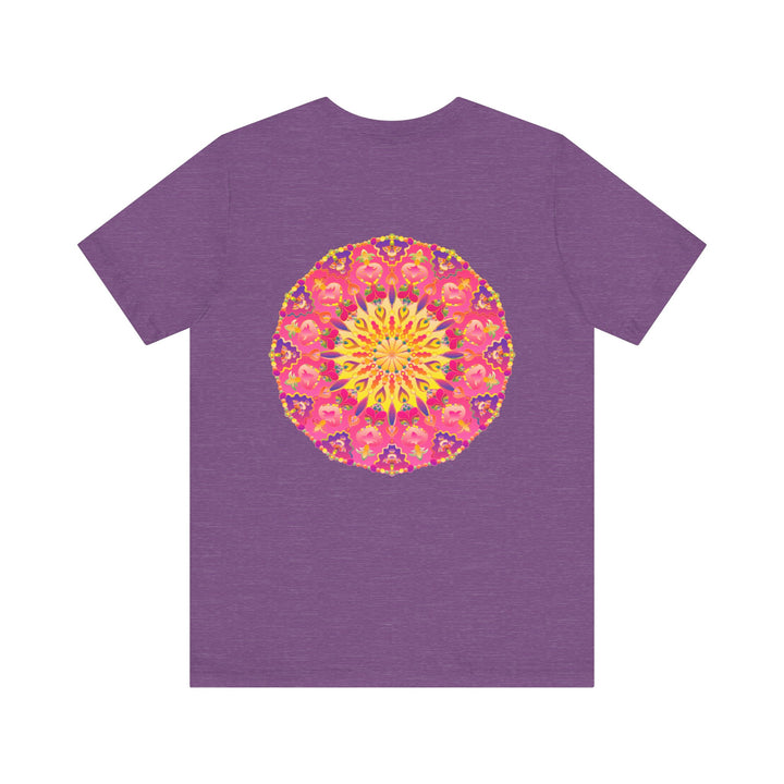 A vibrant and colorful pink and yellow mandala T-shirt featuring a design that represents peace and harmony