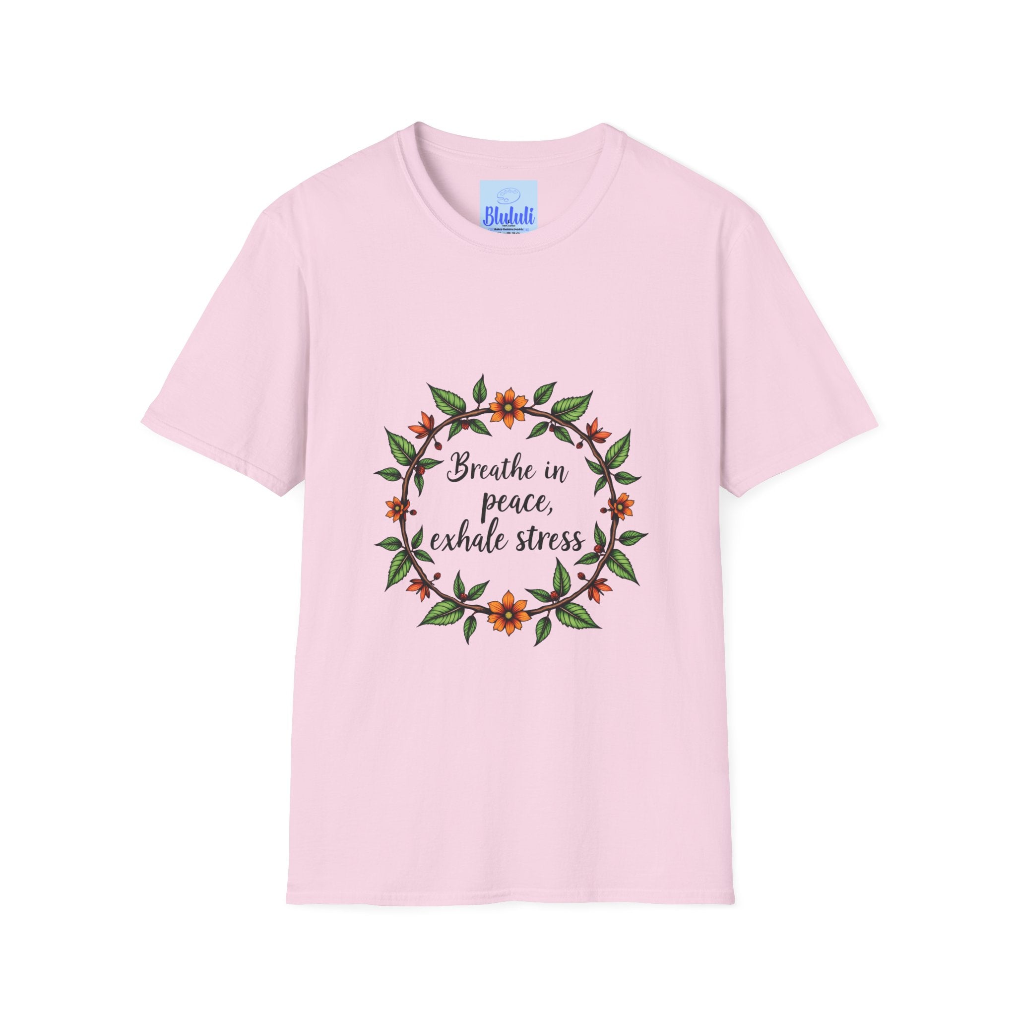 A white t-shirt with a colorful floral garland design and the text Breathe in Peace Exhale Stress in a calming, script font