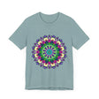 A close-up image of a vibrant mandala tee featuring a colorful and intricate design with bold patterns and beautiful details in various shades of red, blue, yellow, and green