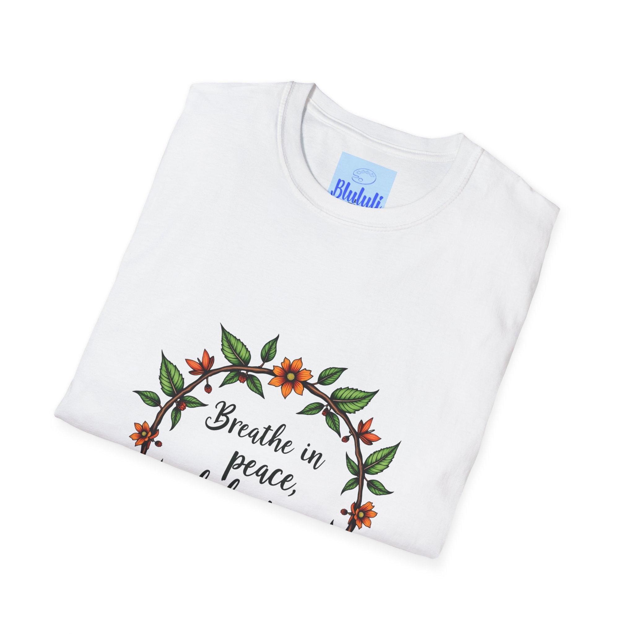 Close up image of a white t-shirt with a floral garland design and the text 'Breathe in Peace Exhale Stress', perfect for adding a touch of zen to your wardrobe