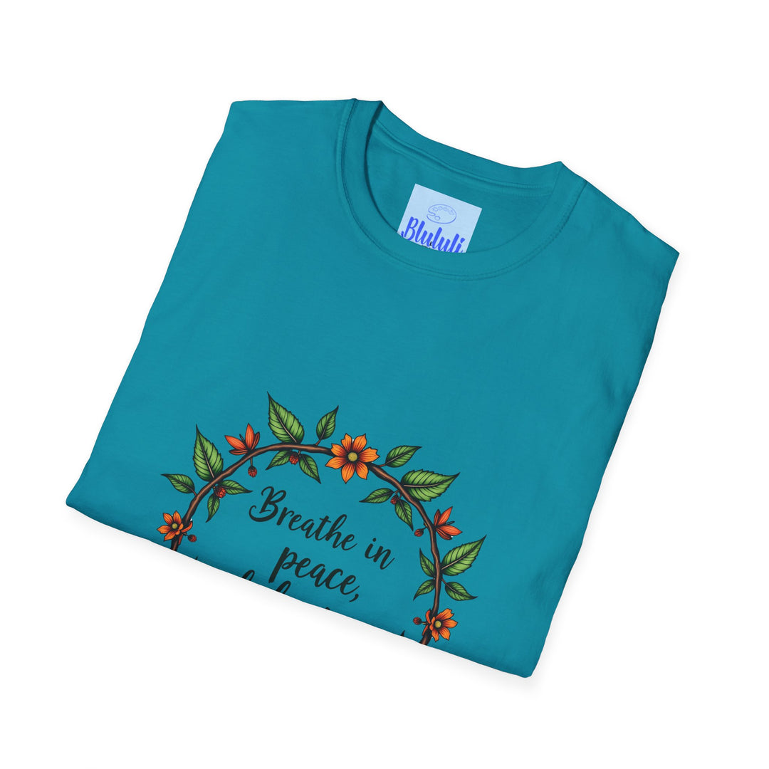 An image of a white T-shirt with a beautiful floral garland design and the words 'Breathe in Peace Exhale Stress' printed on it, perfect for a relaxed and peaceful look