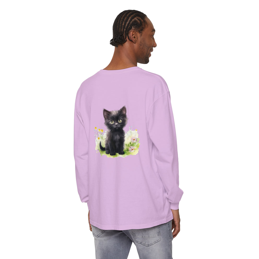 A black kitten wearing a flower crown in a colorful garden on a long sleeve t-shirt