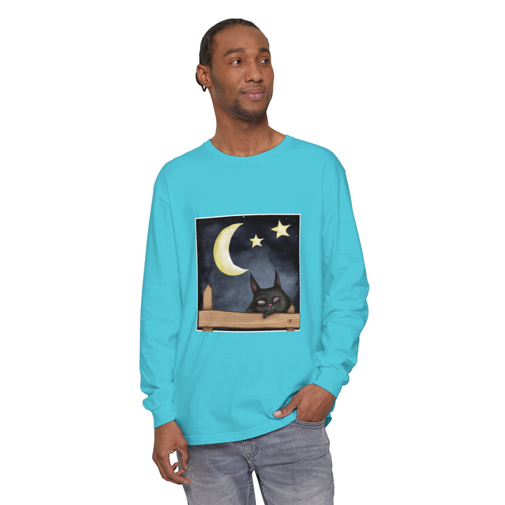 A close-up image of a black t-shirt with a sleepy cat and a night sky design