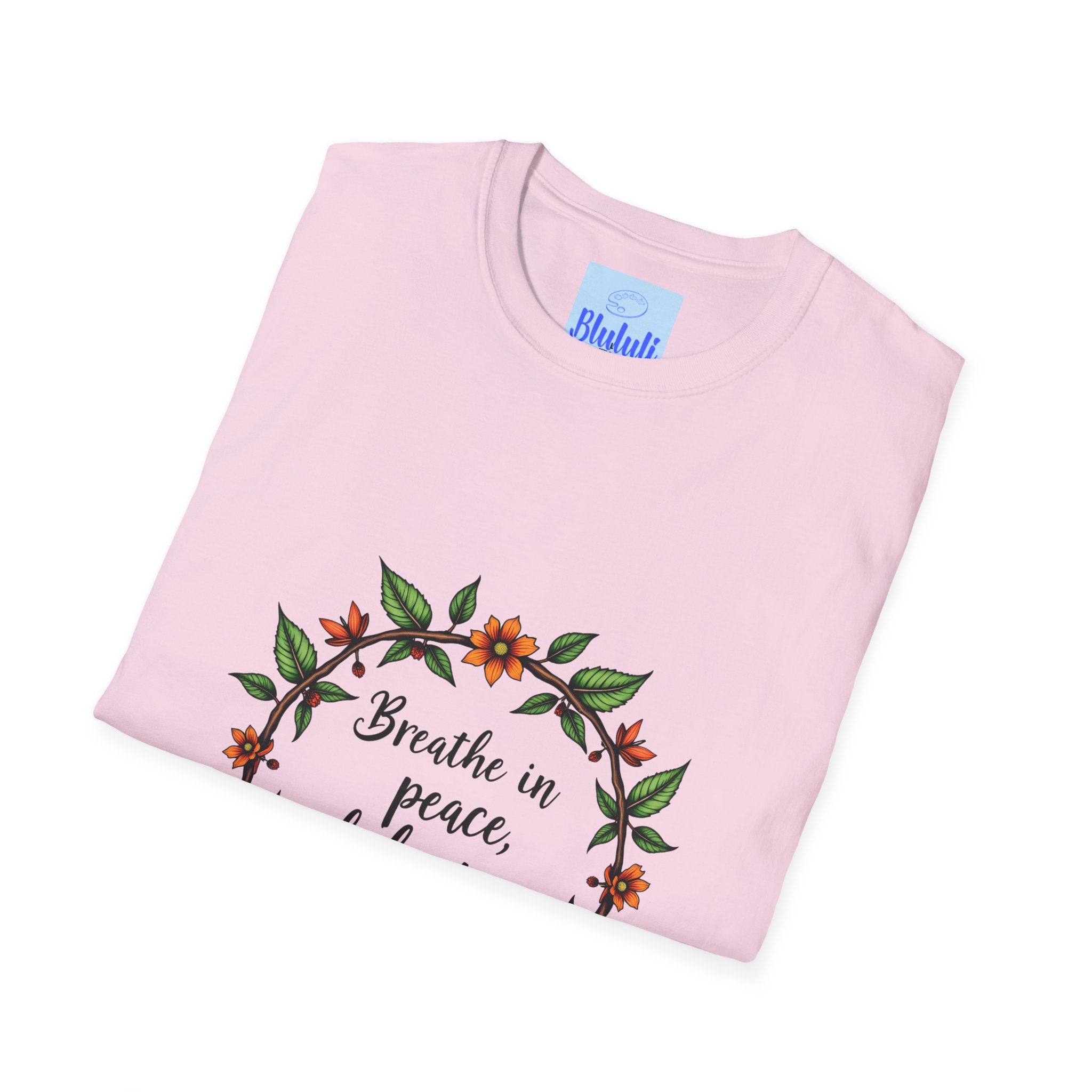 A white t-shirt with a floral garland design and the text Breathe in Peace Exhale Stress in black font