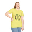 A close-up image of a white t-shirt with a floral garland design and the words Breathe in Peace Exhale Stress printed on it
