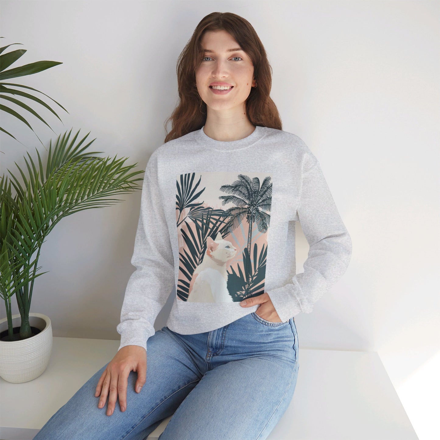 A cozy unisex sweatshirt featuring a cute cat under palm trees