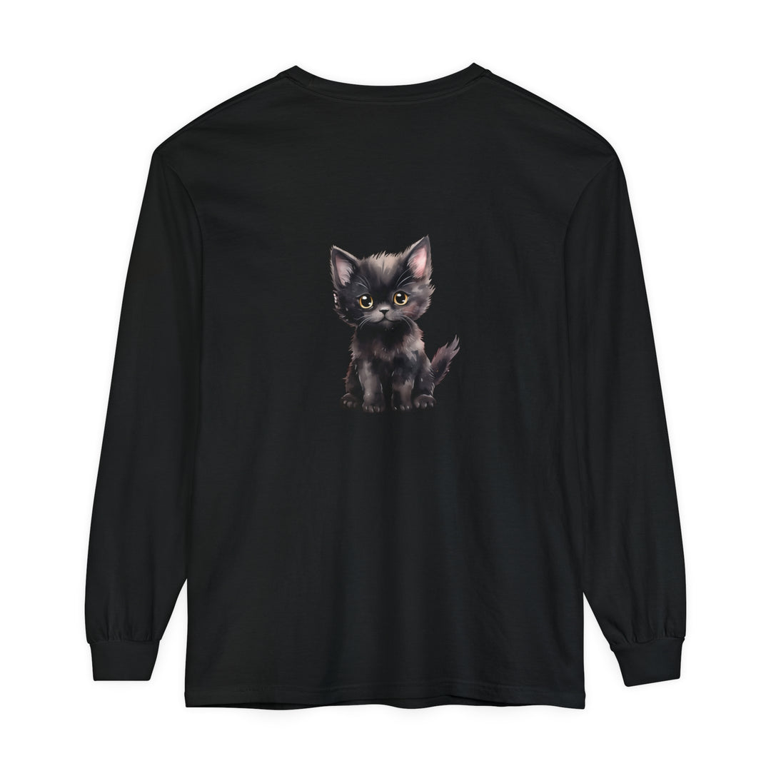 Adorable black kitten with striking yellow eyes sitting on a comfortable long sleeve t-shirt