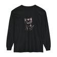 Adorable black kitten with striking yellow eyes sitting on a comfortable long sleeve t-shirt