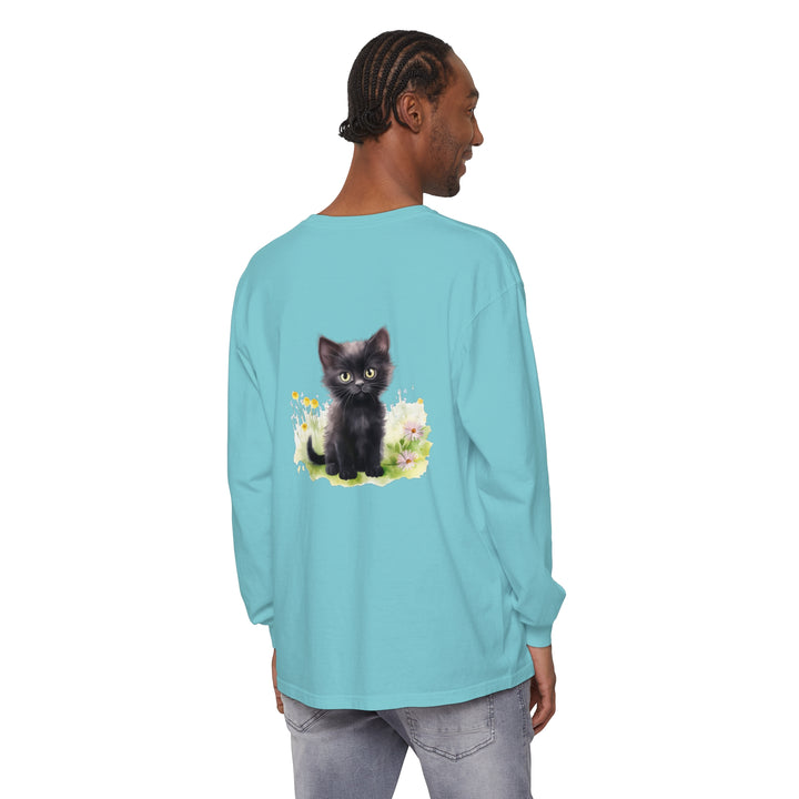 Adorable black kitten lounging in a vibrant flower garden on a long sleeve t-shirt