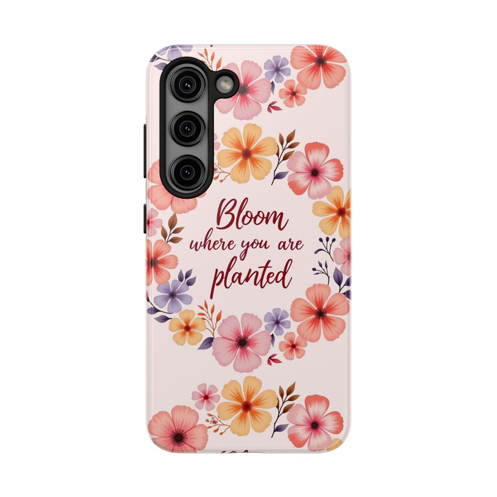 Light pink phone case with flower garland design, perfect for blooming wherever you are planted, available for purchase