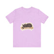 A watercolor illustration of a realistic black cat sleeping on a t-shirt, with intricate details and vibrant colors