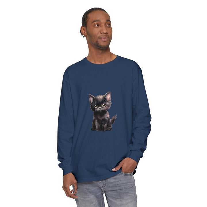 A cute black kitten with piercing yellow eyes on a long sleeve t-shirt