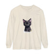 Adorable black kitten with bright green eyes sitting on a t-shirt