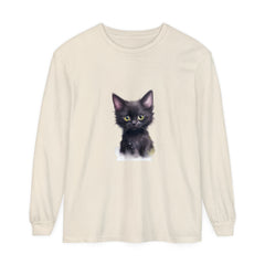 Adorable black kitten with bright green eyes sitting on a t-shirt