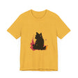 A close-up image of a Black Cat Mystery T-Shirt featuring colorful splatter art design in black, purple, and teal, creating a vibrant and eye-catching effect