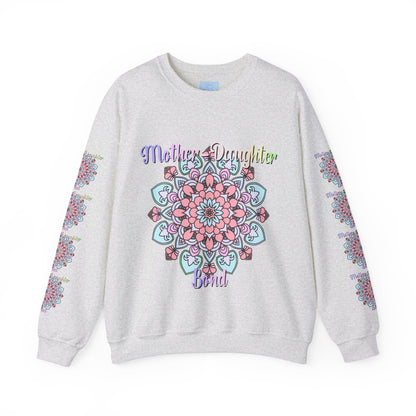 Mother and daughter holding hands and smiling, wearing matching 'Mother-Daughter Bond' Unisex Heavy Blend™ Crewneck Sweatshirts, the perfect birthday gift for mom