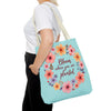 A beautiful floral tote bag with the quote Bloom Where You Are Planted available in three different sizes