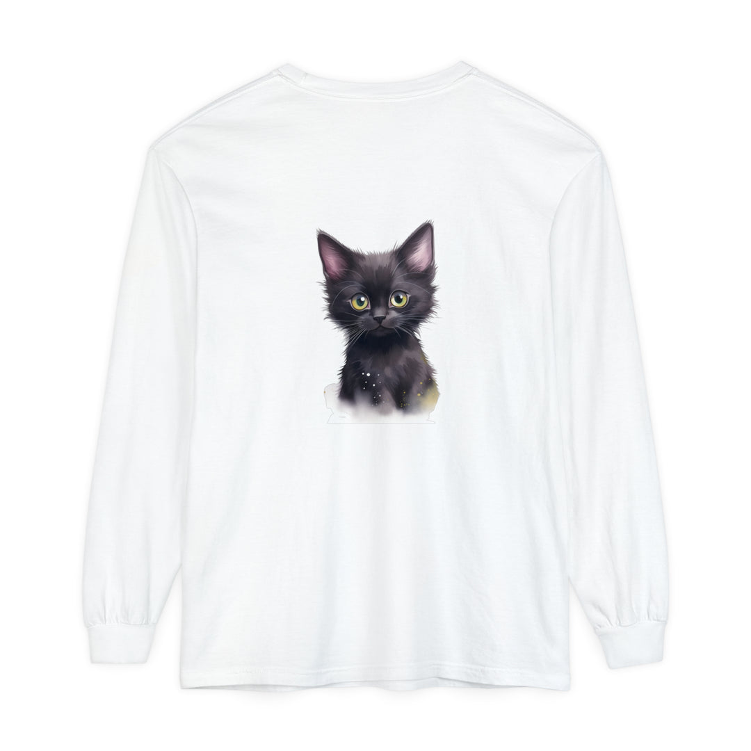 A charming black kitten with bright green eyes sitting on a soft white cotton t-shirt