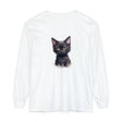 A charming black kitten with bright green eyes sitting on a soft white cotton t-shirt