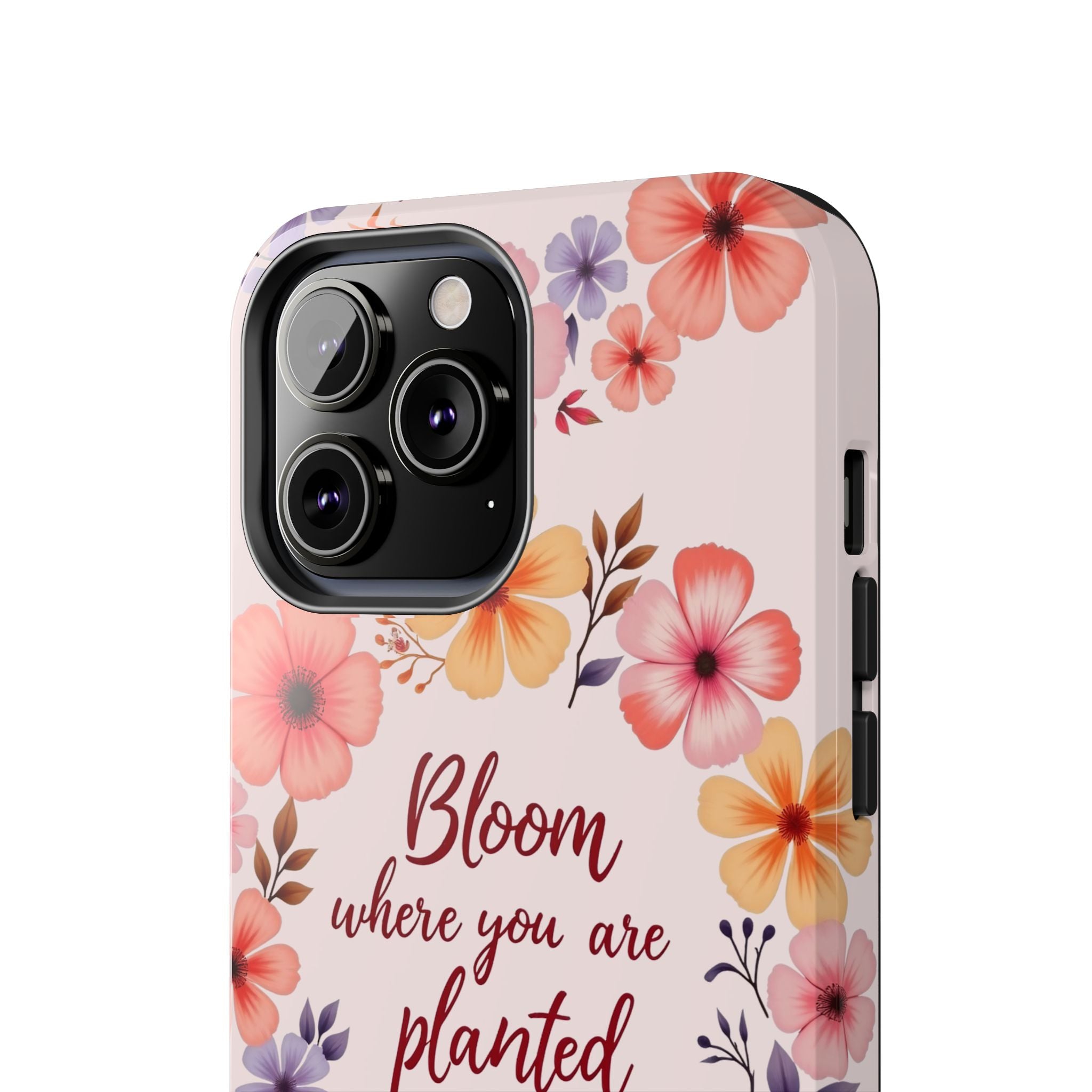 Light pink phone case with a beautiful flower garland design that says 'bloom where you are planted' on it