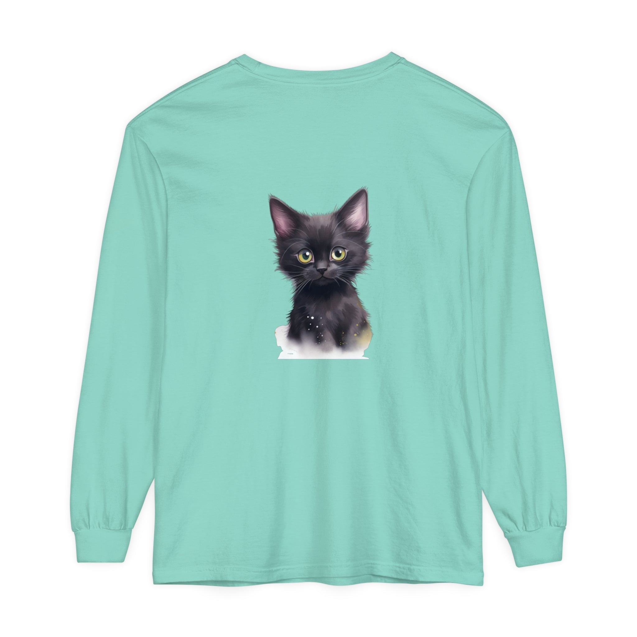 Cute black kitten with bright green eyes sitting on a white t-shirt