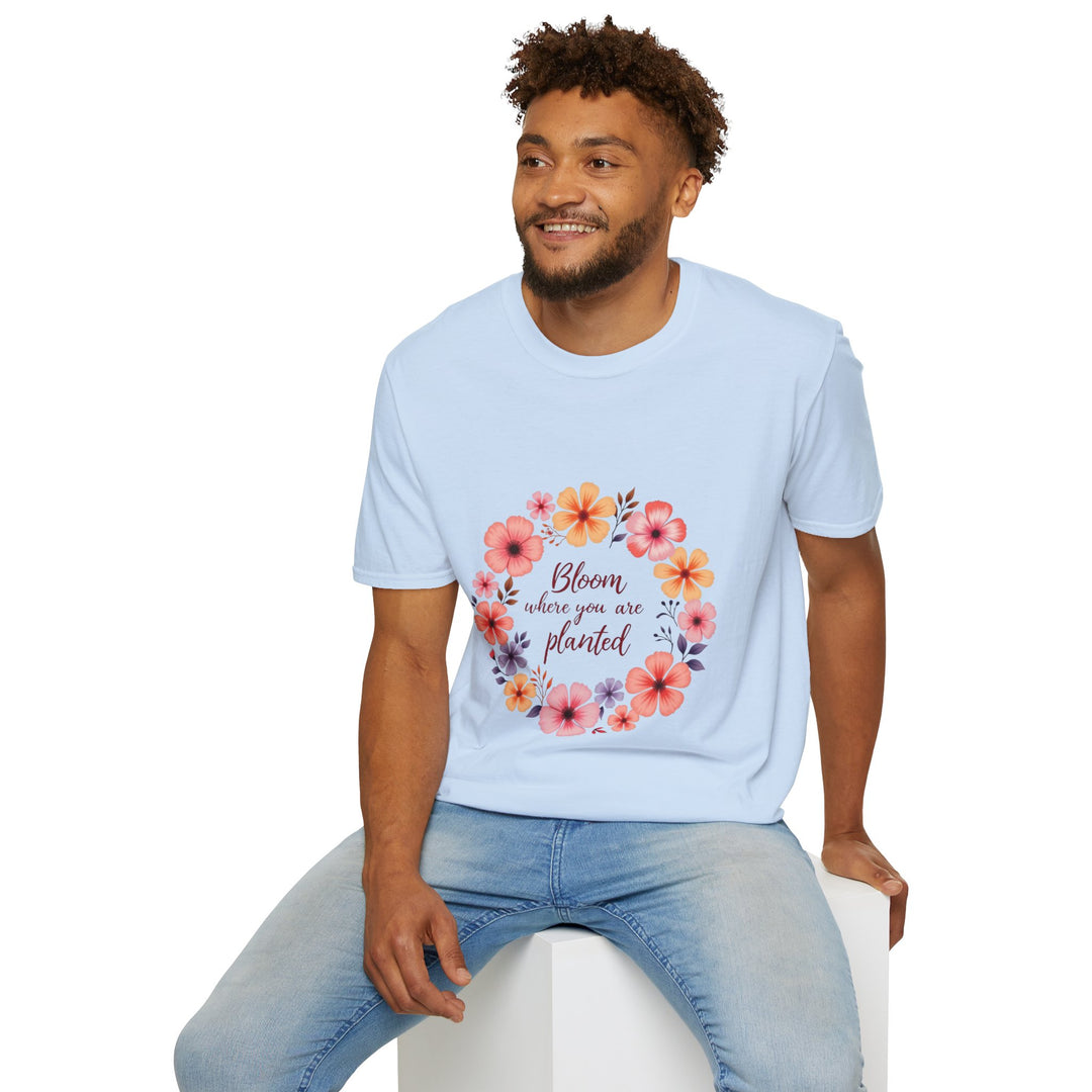 A close-up image of a white t-shirt with a vibrant floral mandala design and a quote printed in the center