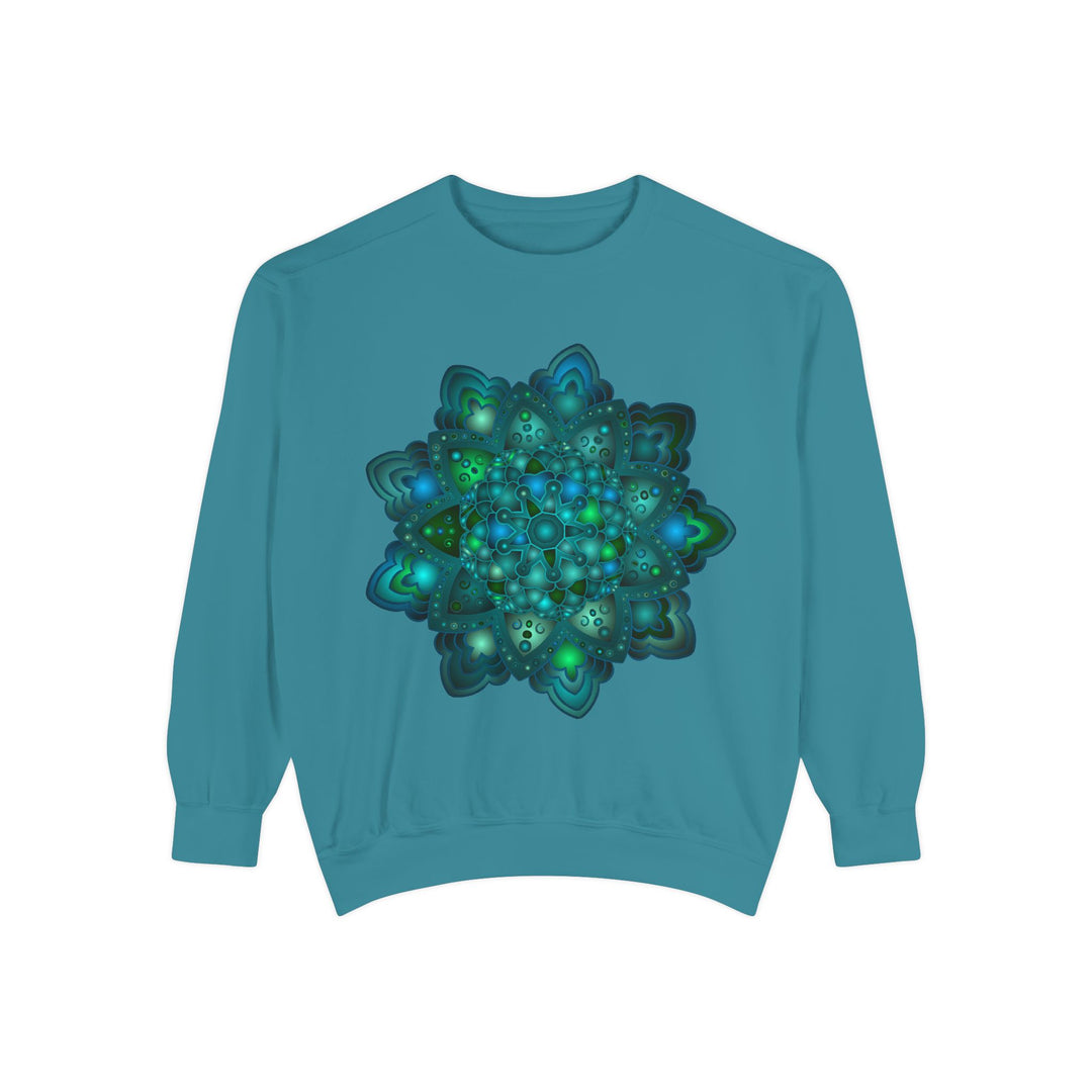 A close-up image of an intricate blue and green mandala sweatshirt with detailed patterns and vibrant colors