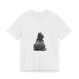 A black t-shirt featuring a mystical illustration of a cat with glowing eyes and a moon in the background