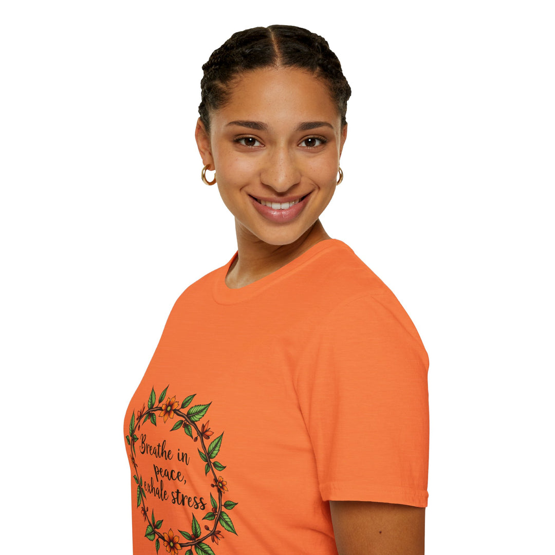 A woman wearing a white t-shirt with a floral garland design, featuring the text Breathe in Peace Exhale Stress