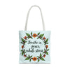 A woman holding a white tote bag with a floral crown design, perfect for a serene and stylish look