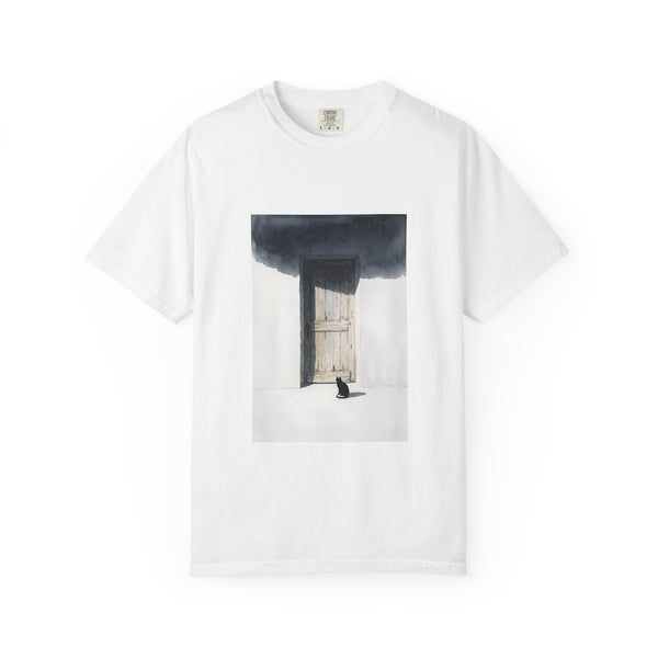 A white short-sleeve crewneck t-shirt featuring a rectangular graphic print of a dark, moody painting depicting a wooden door, a black cat, and a shadow.