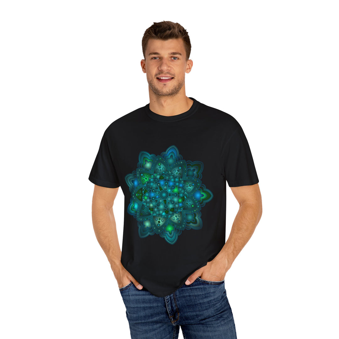 A close-up image of a unisex t-shirt featuring an intricate blue and green mandala design