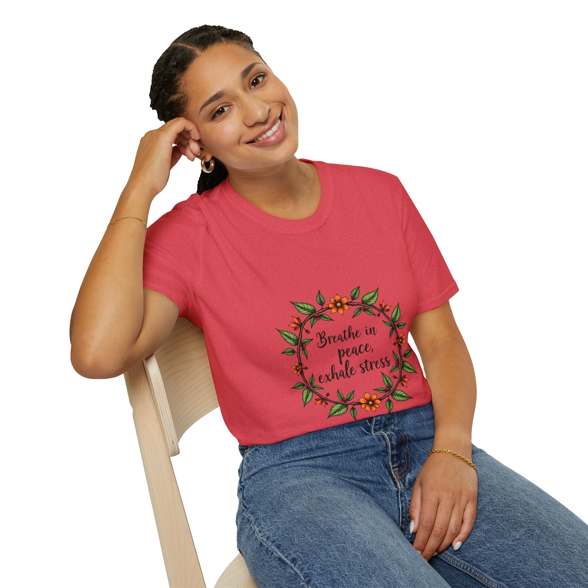 A close-up image of a white t-shirt with a colorful floral garland print and the phrase Breathe in Peace Exhale Stress in cursive lettering