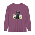 A cute black kitten exploring a colorful flower garden on a long sleeve t-shirt
