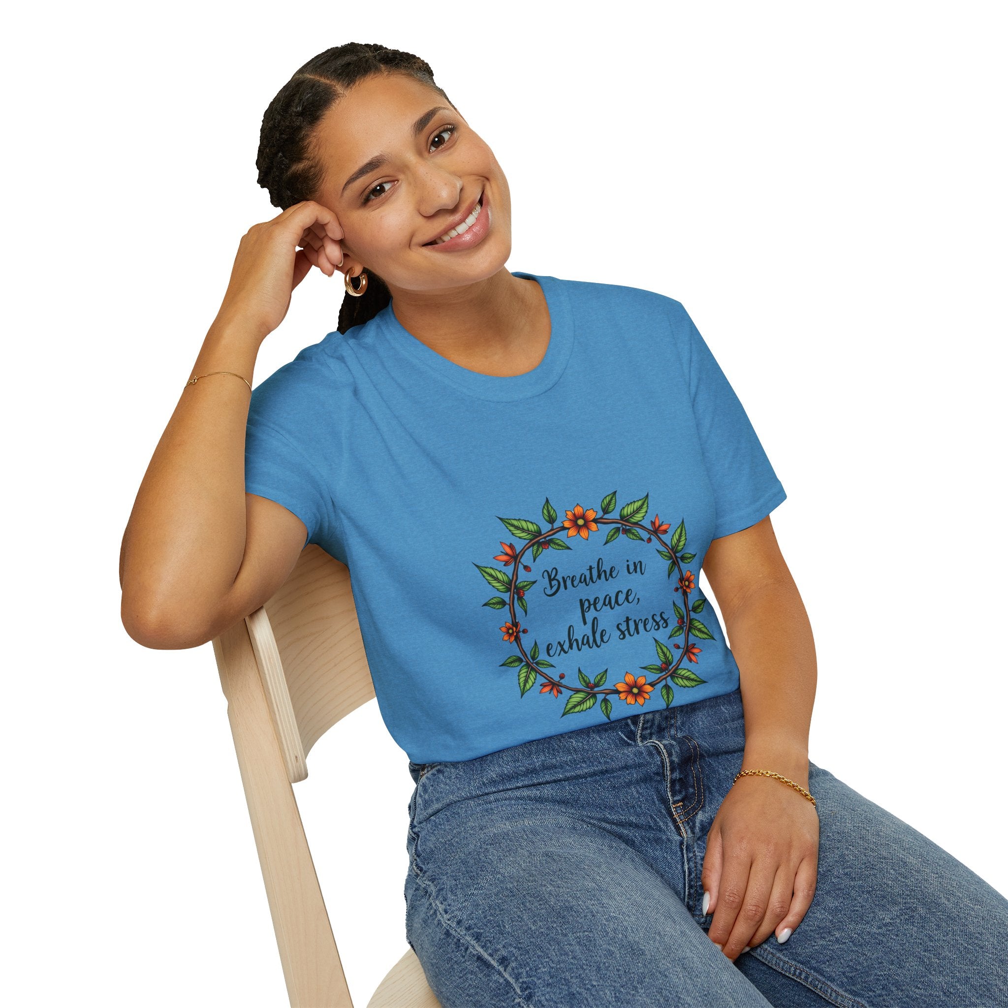 A close-up image of a white t-shirt with a colorful floral garland design and the words Breathe in Peace Exhale Stress in a calming font