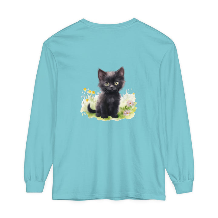 A cute black kitten sitting in a vibrant flower garden, featured on a long sleeve t-shirt