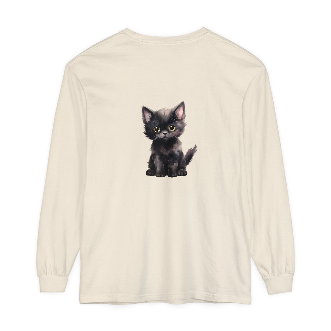 A cute black kitten with vibrant yellow eyes on a long sleeve t-shirt