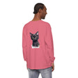 A black kitten with green eyes sitting on a t-shirt, looking cute and playful