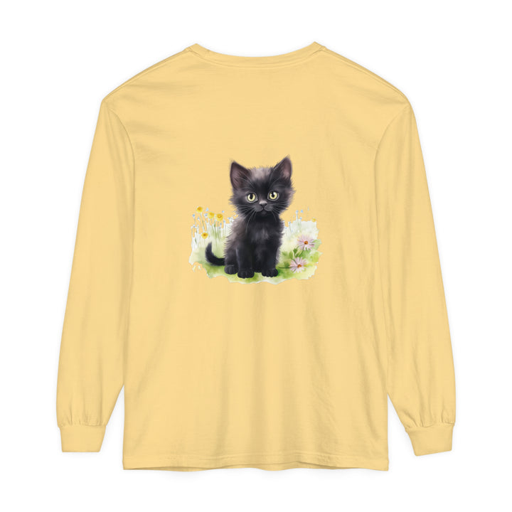 A cute black kitten sitting in a vibrant flower garden, printed on a long sleeve t-shirt