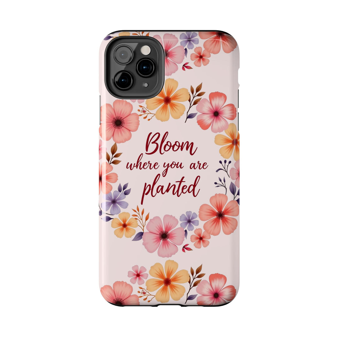 Light pink phone case with a beautiful flower garland design called 'Bloom where you are planted'