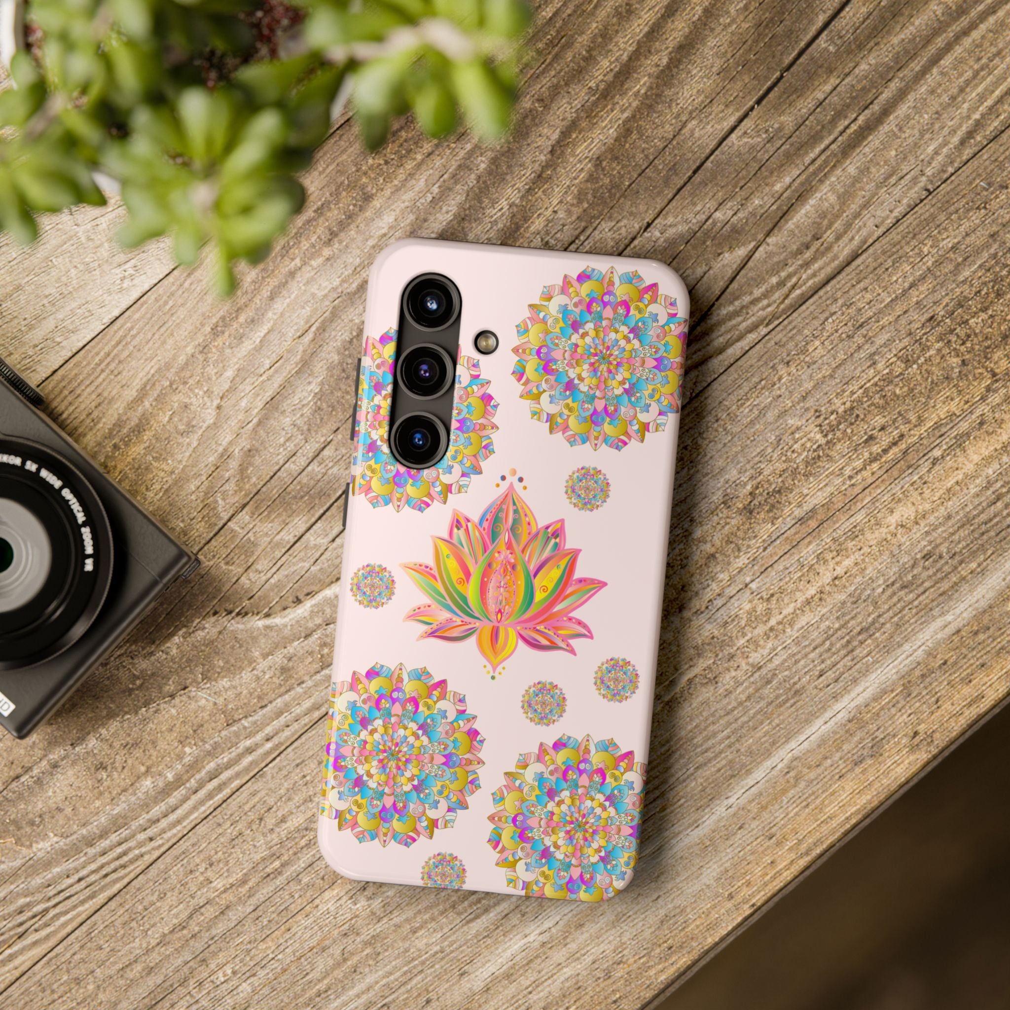 A close-up image of a light pink phone case with a beautiful lotus flower mandala design, perfect for adding style and protection to your phone