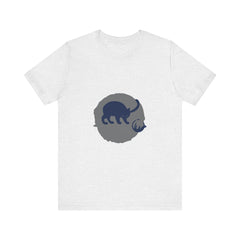 A black cat with glowing green eyes sits playfully in silhouette on a mystery t-shirt