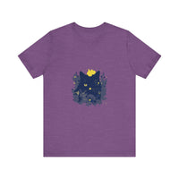 A black cat with a mischievous expression wearing a t-shirt featuring whimsical flowers