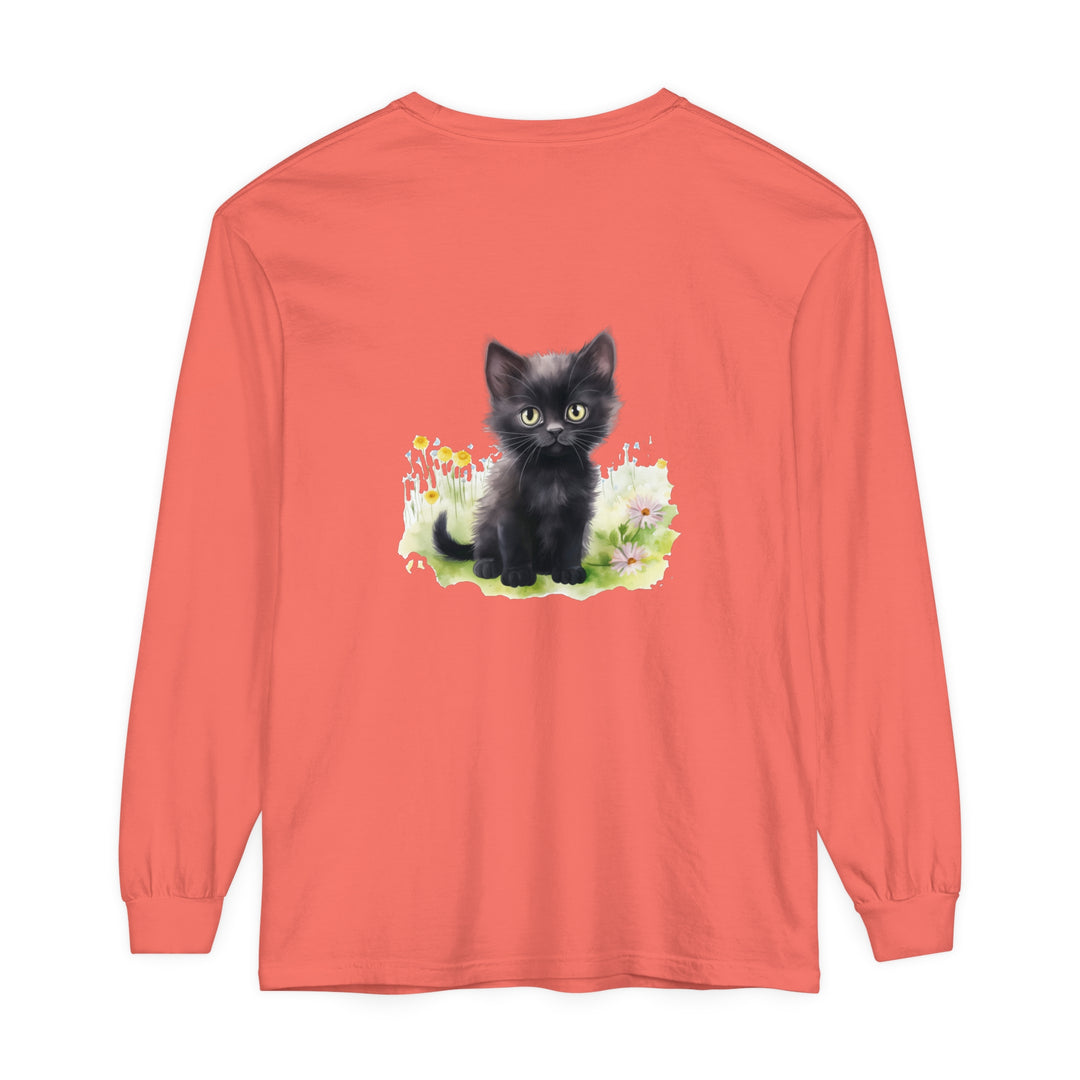 A cute black kitten frolicking in a vibrant flower garden, printed on a long sleeve t-shirt