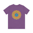 A colorful and intricate mandala design featuring symbols of peace and harmony on a vibrant t-shirt