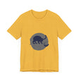 A black cat with bright green eyes, sitting in a playful silhouette against a full moon on a black mystery t-shirt