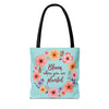 Colorful floral tote bag with the quote 'Bloom Where You Are Planted' available in small, medium, and large sizes