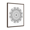 A stunning black and white handmade mandala art piece on gallery canvas wraps, beautifully displayed in a vertical frame